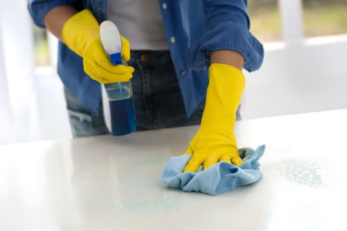 Professional commercial cleaner disinfecting high-touch surfaces